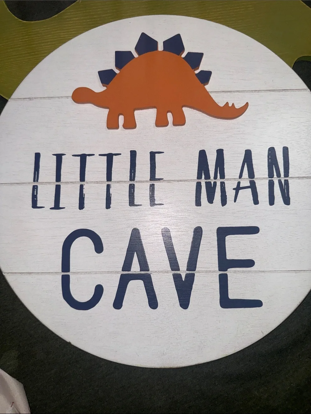Blue and Orange 'Little Man Cave' Wall Sign and Green brontosaurus sign.